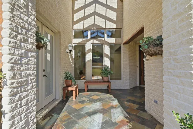 a living room with a large windows and a chandelier