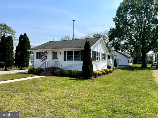 a view of a house with a big yard and potted plants