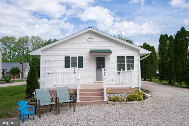 a view of a house with backyard and a tree