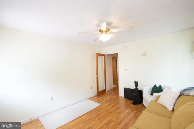 a view of a big room with closet and a chandelier fan