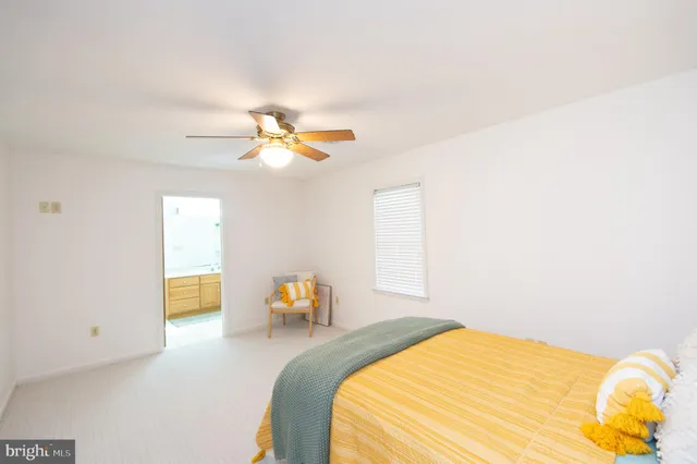 an empty room with fan and windows