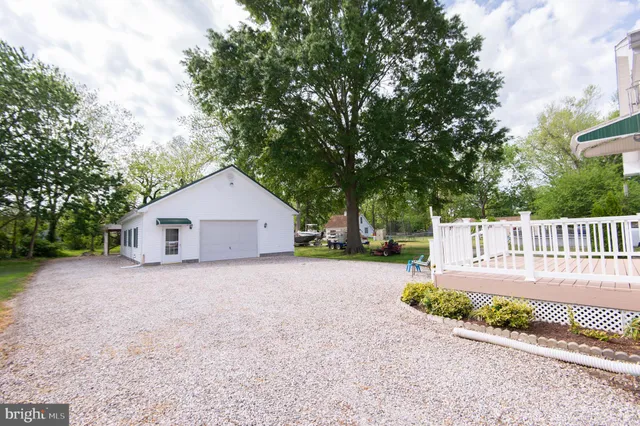 a view of a house with a backyard and garage