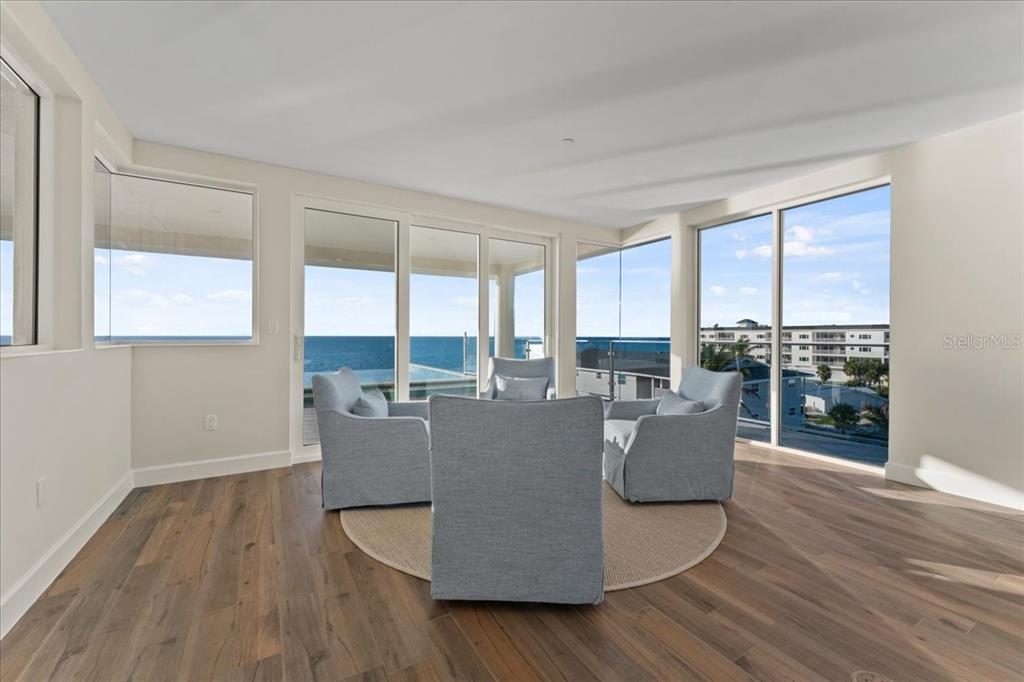 2708 North Beach Road, Unit 5 Englewood, FL 34223 - Photo 18 of 82 a living room with furniture a large window and wooden floor