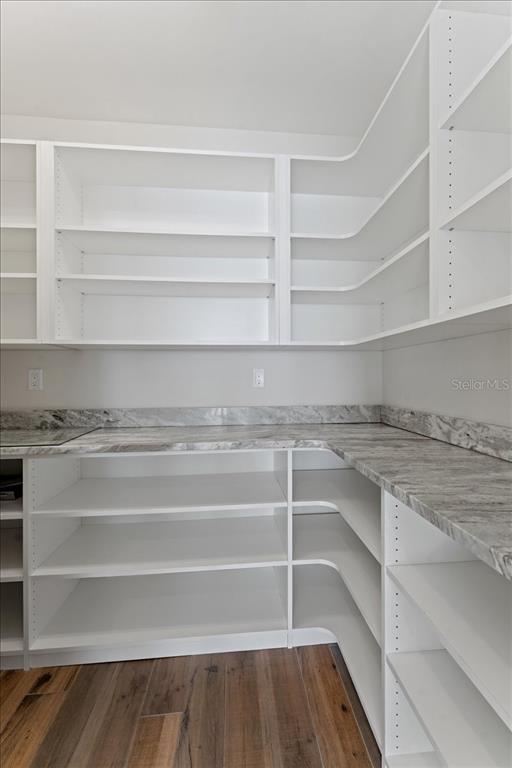 2708 North Beach Road, Unit 5 Englewood, FL 34223 - Photo 32 of 82 a view of a walk in closet with empty racks