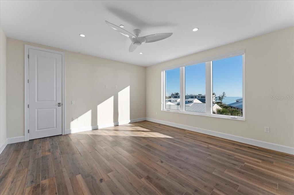 2708 North Beach Road, Unit 5 Englewood, FL 34223 - Photo 40 of 82 a view of an empty room with a window and wooden floor