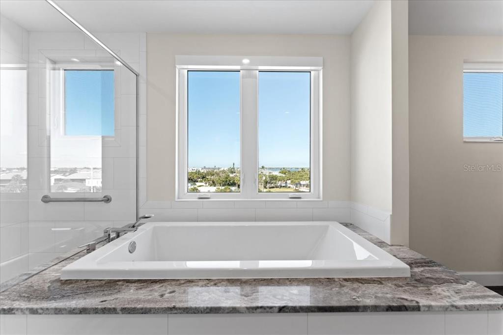 2708 North Beach Road, Unit 5 Englewood, FL 34223 - Photo 49 of 82 a bathroom with bathtub and window