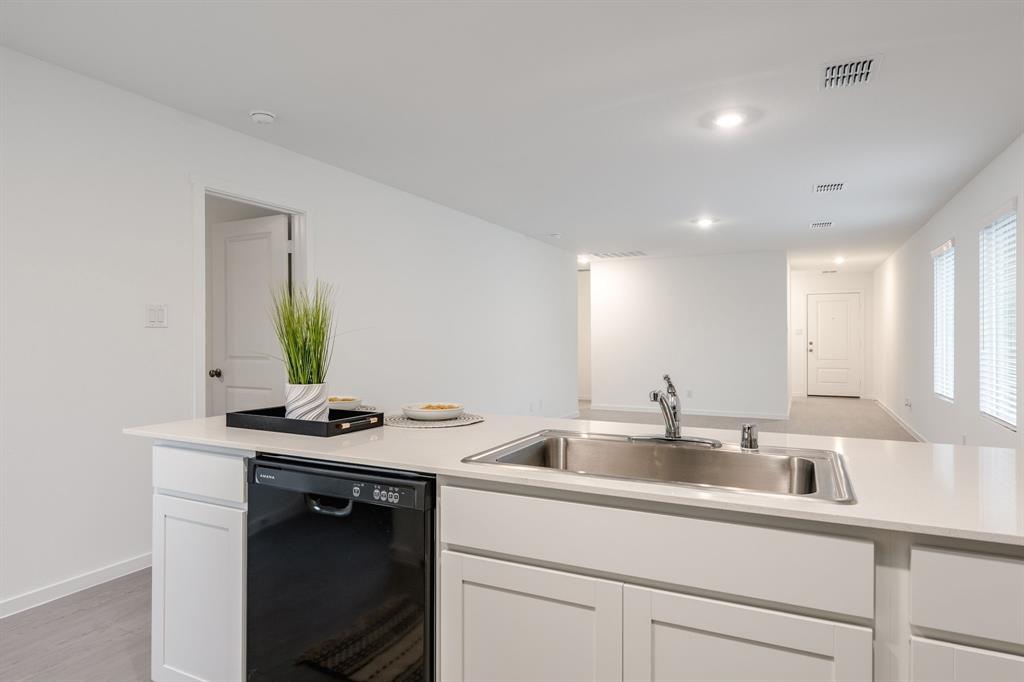 1119 Barbary Flds Street Forney, TX 75126 - Photo 7 of 14 a kitchen with a sink and cabinets