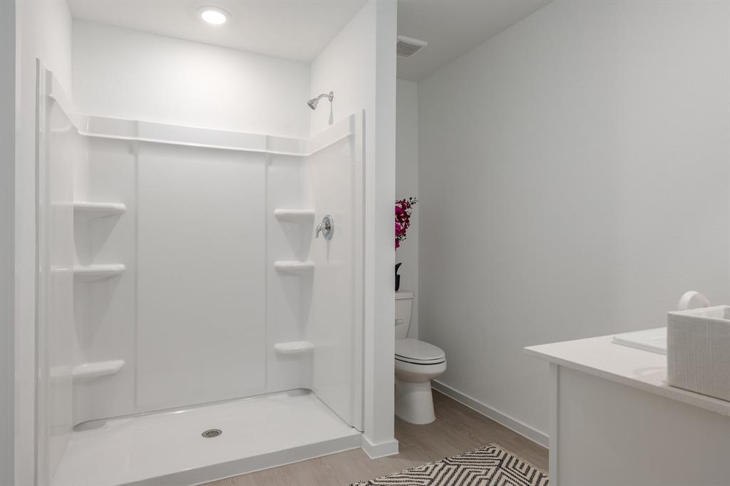 1119 Barbary Flds Street Forney, TX 75126 - Photo 9 of 14 a bathroom with a shower a toilet and a shower