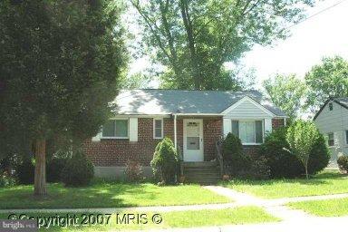 12824 Holdridge Road Silver Spring, MD 20906 - Photo 1 of 1 a front view of house with yard and green space