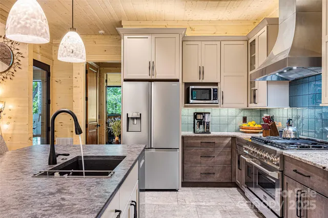 a kitchen with granite countertop a stove and a sink