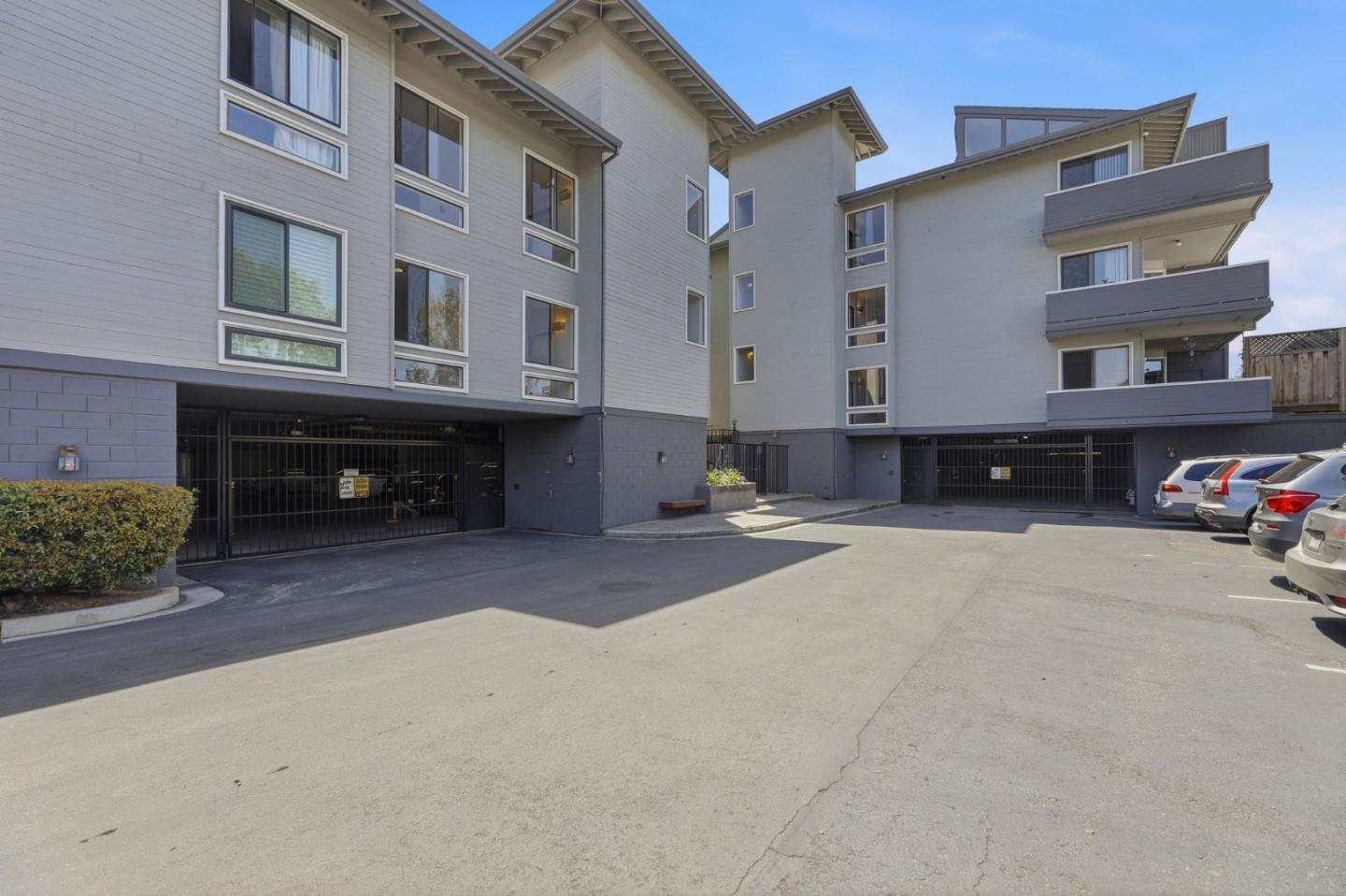 22330 Homestead Road, Unit 226 Cupertino, CA 95014 - Photo 30 of 38 a front view of a house with a yard and a garage
