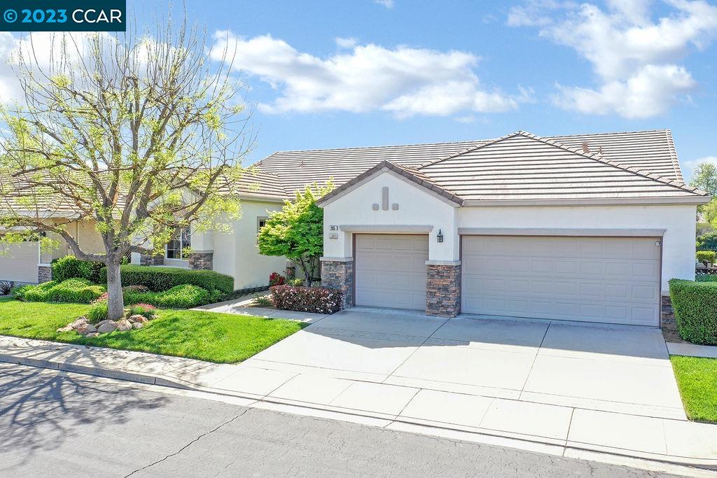 a front view of a house with a garden and entryway