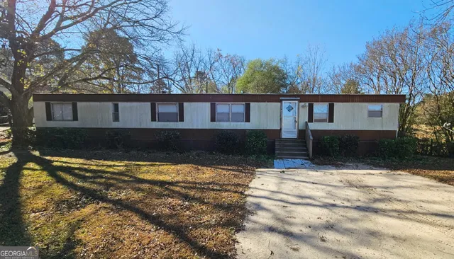a view of house with yard