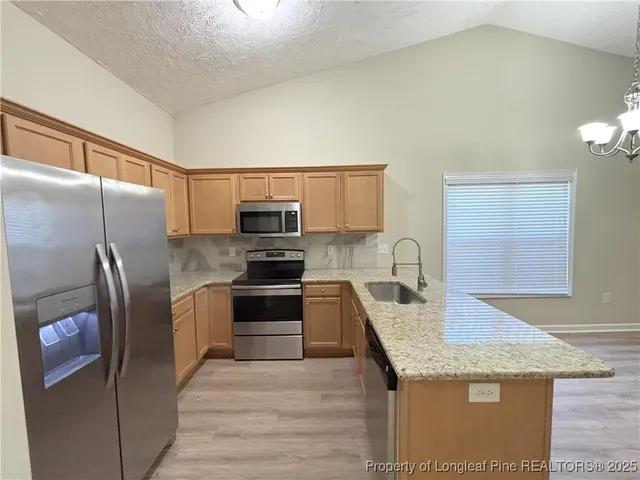 a kitchen with a sink stove and refrigerator