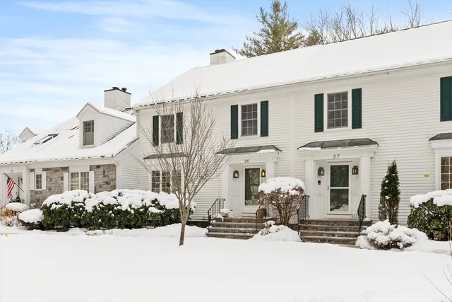 a front view of a house with a yard covered in snow