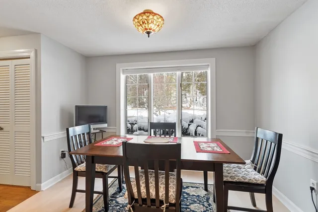 a view of a dining room with furniture and a large window