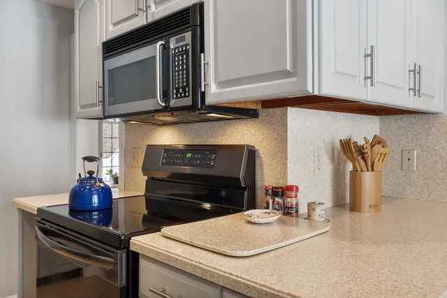 a kitchen with a stove and a microwave