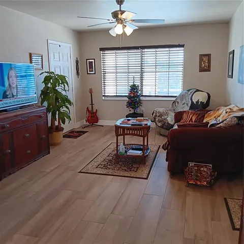 a living room with furniture a chandelier and a window