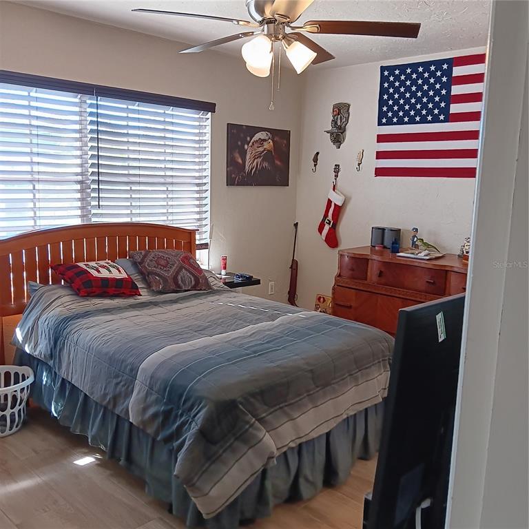 4158 Tamiami Trail, Unit R8 Port Charlotte, FL 33952 - Photo 15 of 29 a bedroom with a bed and a chandelier