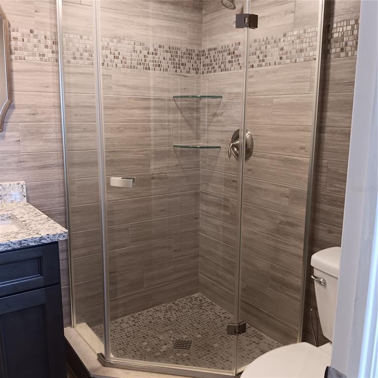 4158 Tamiami Trail, Unit R8 Port Charlotte, FL 33952 - Photo 19 of 29 a bathroom with a toilet and a shower