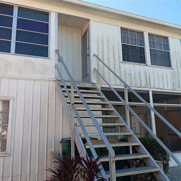 4158 Tamiami Trail, Unit R8 Port Charlotte, FL 33952 - Photo 22 of 29 a view of staircase with wooden floor and white walls