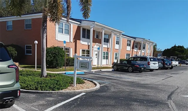 a view of a house with a big yard and potted plants