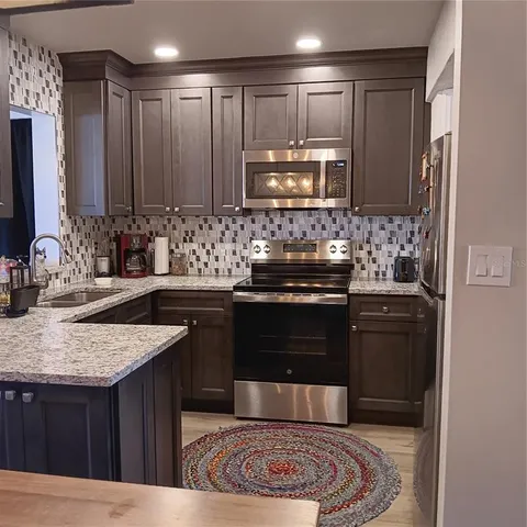 a kitchen with a stove and a refrigerator