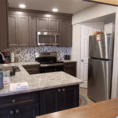a kitchen with a sink and refrigerator
