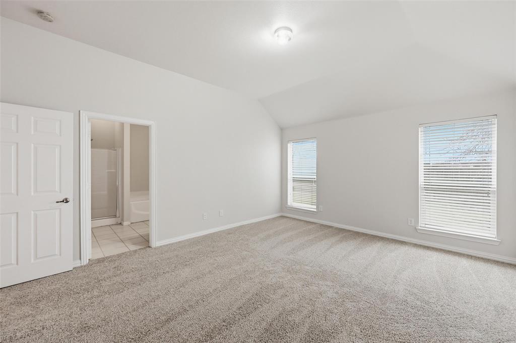 4416 Ridgeway Drive Mansfield, TX 76063 - Photo 13 of 27 Primary bedroom with new carpet and lofted ceiling