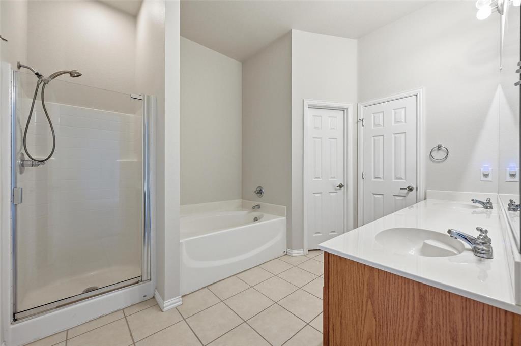4416 Ridgeway Drive Mansfield, TX 76063 - Photo 15 of 27 Bathroom with double vanity, garden tub, separate shower, and neutral tile