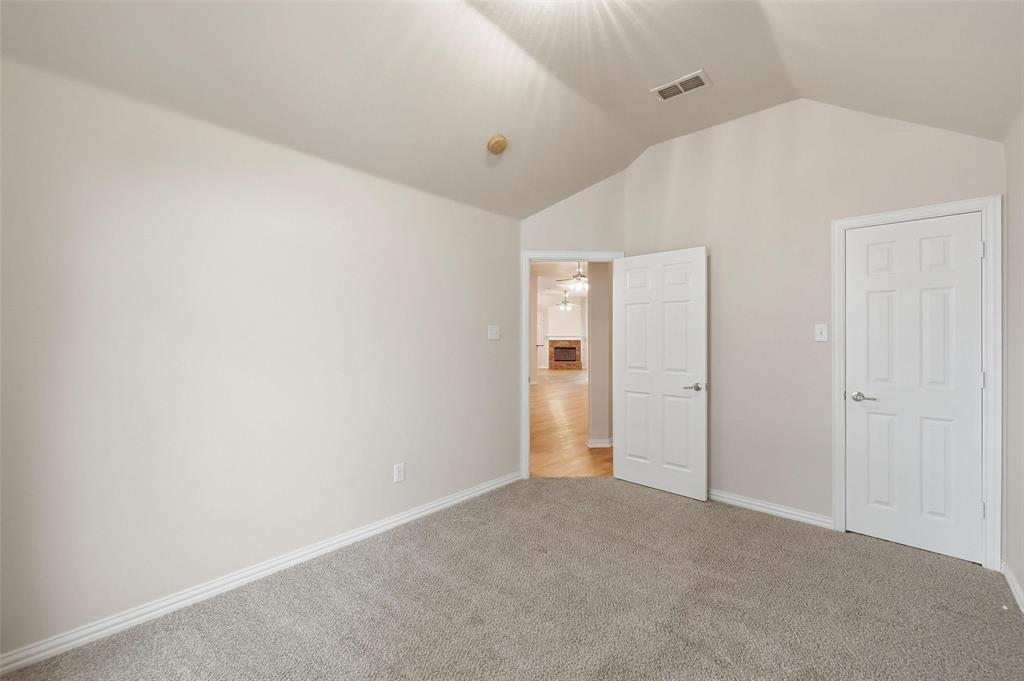4416 Ridgeway Drive Mansfield, TX 76063 - Photo 21 of 27 Front bedroom with walk in closet and view into living room