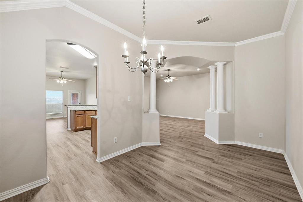 4416 Ridgeway Drive Mansfield, TX 76063 - Photo 7 of 27 Dining area featuring crown molding, light wood-style floors, a decorative chandelier and arched walkways