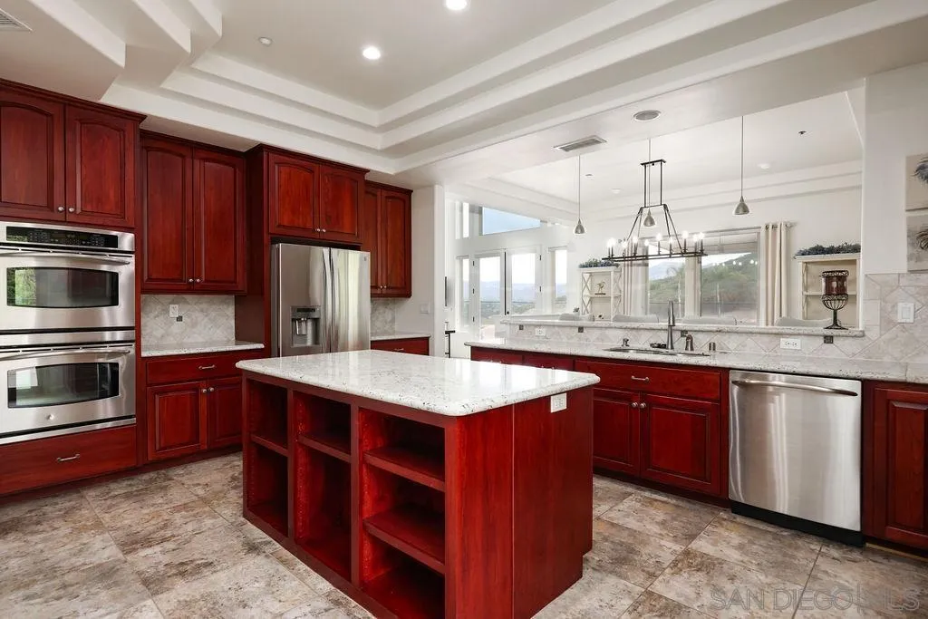 23085 Tombill Road Ramona, CA 92065 - Photo 11 of 43 a kitchen with stainless steel appliances granite countertop a sink stove and refrigerator