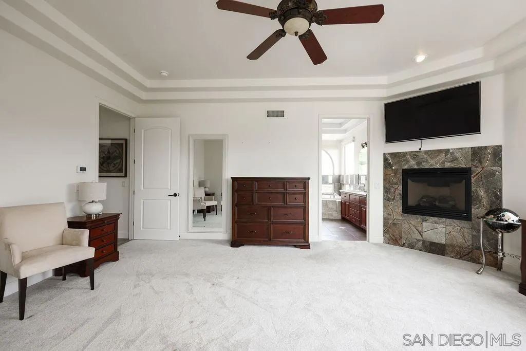23085 Tombill Road Ramona, CA 92065 - Photo 12 of 43 a living room with furniture a fireplace and a flat screen tv