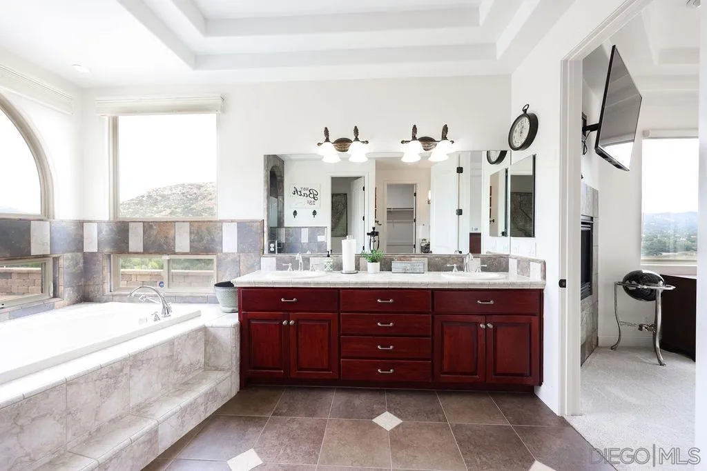 23085 Tombill Road Ramona, CA 92065 - Photo 14 of 43 a spacious bathroom with a tub sink and mirror
