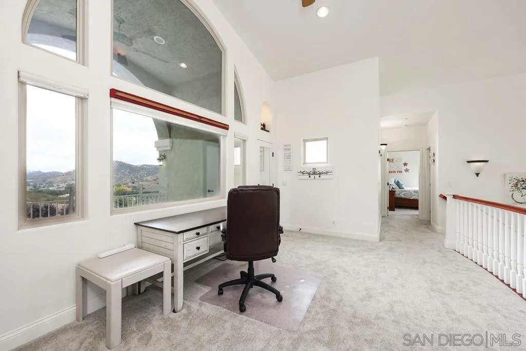 23085 Tombill Road Ramona, CA 92065 - Photo 16 of 43 a view of a workspace with furniture and a window