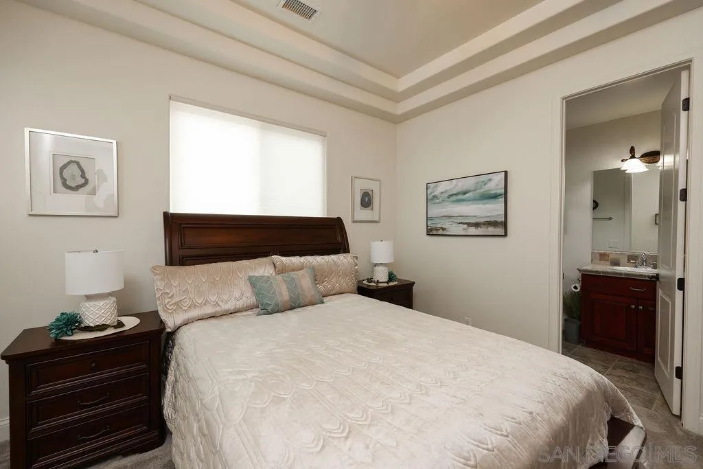 23085 Tombill Road Ramona, CA 92065 - Photo 17 of 43 a bedroom with a bed and wooden floor