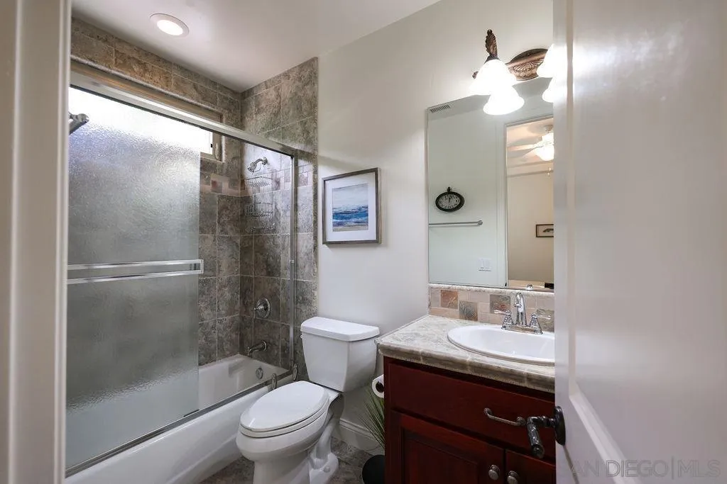 23085 Tombill Road Ramona, CA 92065 - Photo 18 of 43 a bathroom with a granite countertop sink toilet and shower