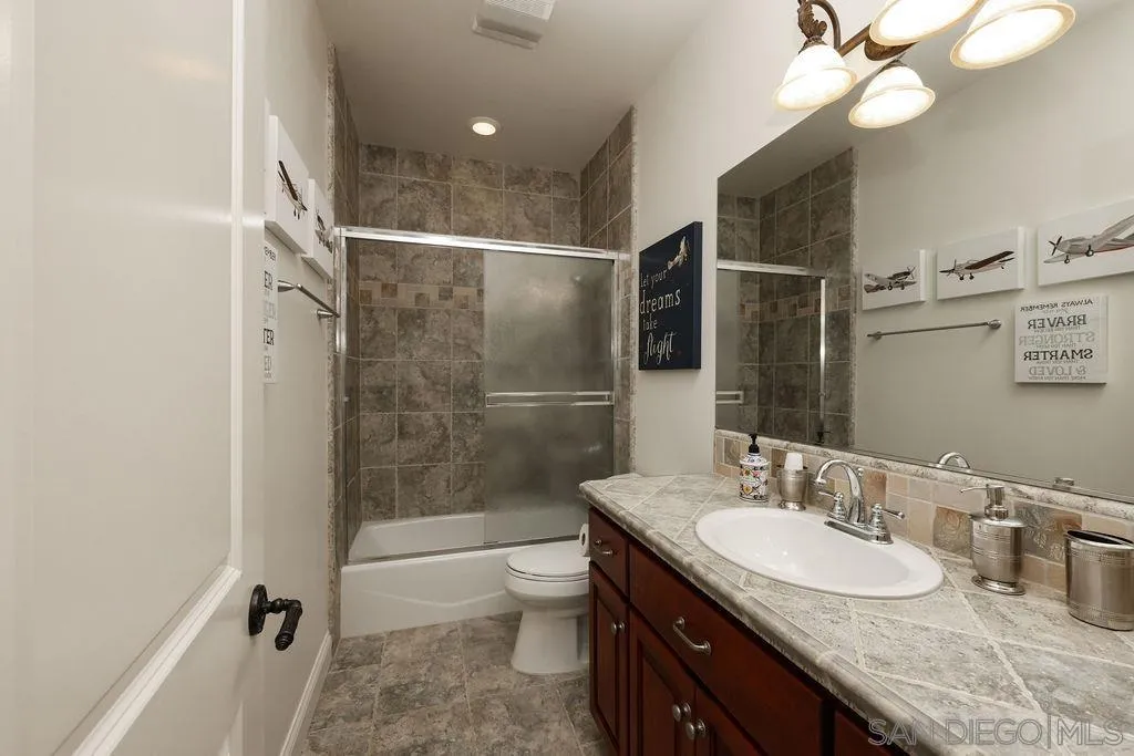 23085 Tombill Road Ramona, CA 92065 - Photo 20 of 43 a bathroom with a granite countertop sink toilet and shower