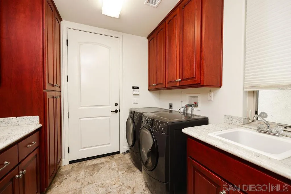23085 Tombill Road Ramona, CA 92065 - Photo 21 of 43 a utility room with sink dryer and washer