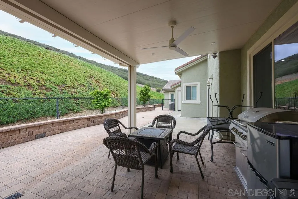 23085 Tombill Road Ramona, CA 92065 - Photo 35 of 43 a view of a patio with table and chairs and wooden floor