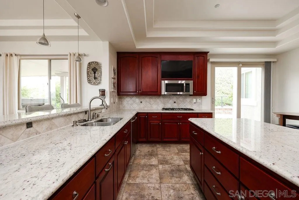23085 Tombill Road Ramona, CA 92065 - Photo 9 of 43 a large kitchen with granite countertop a sink and a window