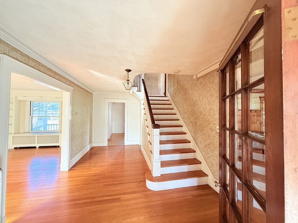 30 Payson Road Belmont, MA 02478 - Photo 8 of 17 a view of an entryway with wooden floor and stairs