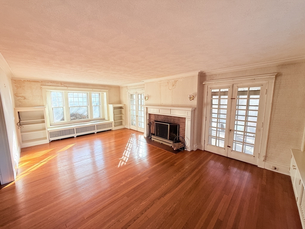 30 Payson Road Belmont, MA 02478 - Photo 9 of 17 a view of empty room with wooden floor and fireplace
