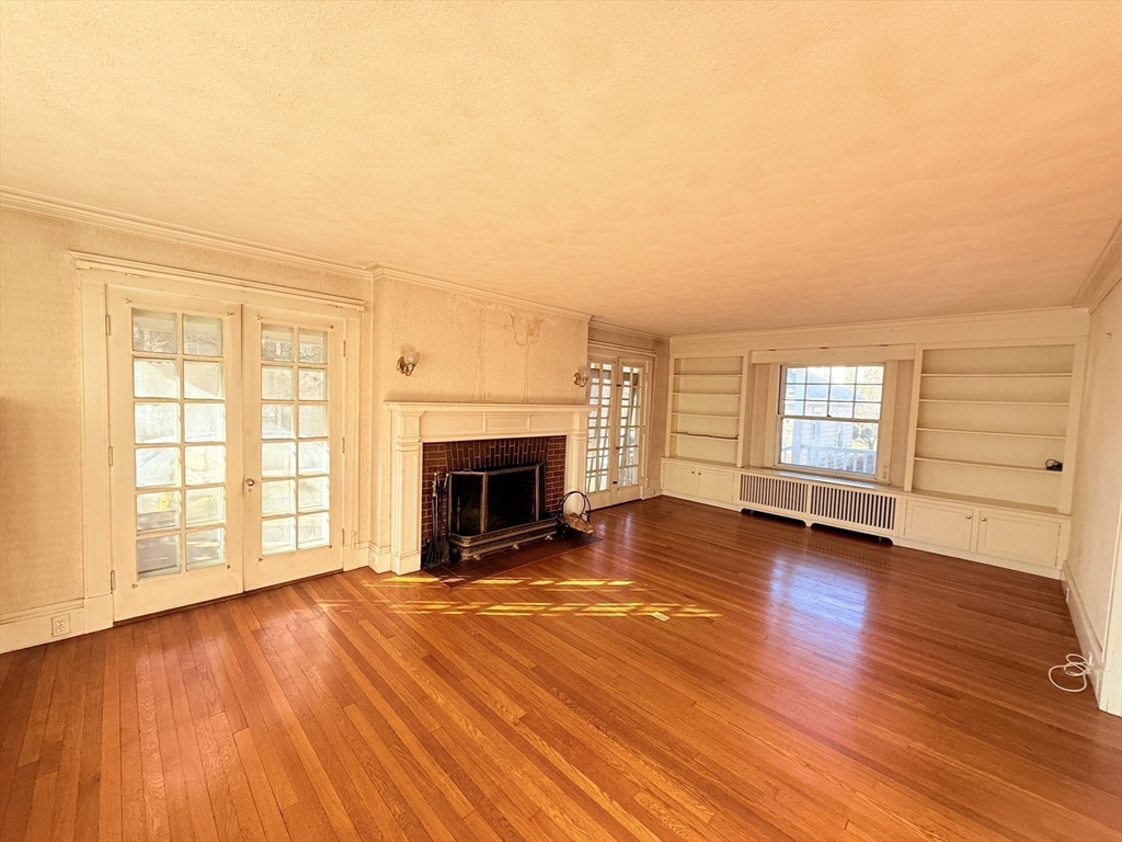 30 Payson Road Belmont, MA 02478 - Photo 10 of 17 an empty room with wooden floor fireplace and windows