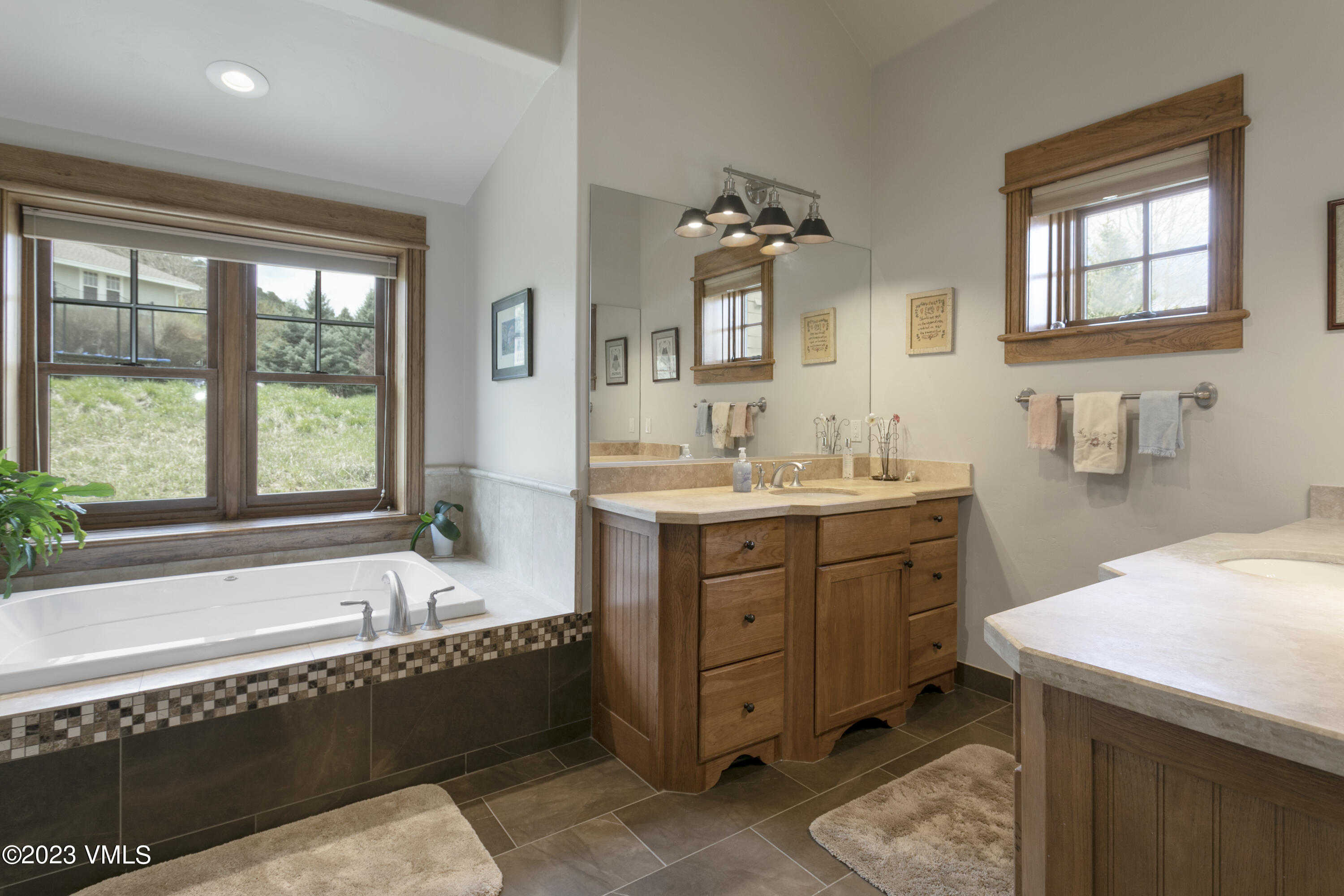 106 East Double Hitch Eagle, CO 81631 - Photo 11 of 28 a bathroom with a tub sink and mirror
