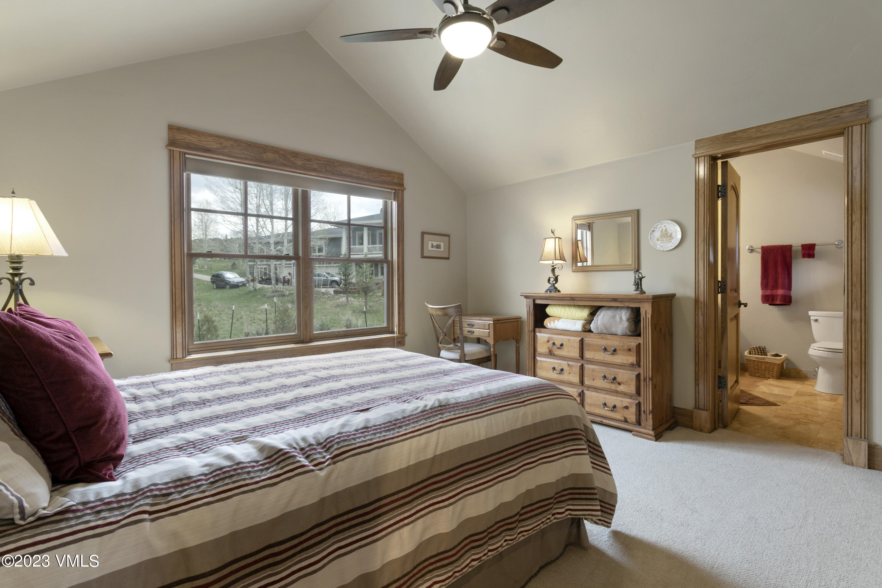 106 East Double Hitch Eagle, CO 81631 - Photo 12 of 28 a bedroom with a bed and a chandelier