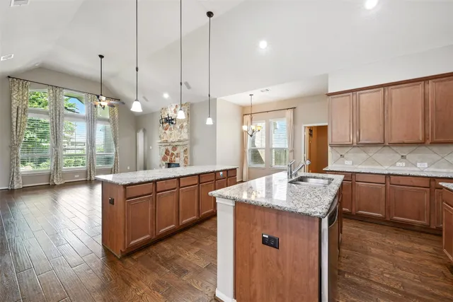 an empty room with a chandelier fan