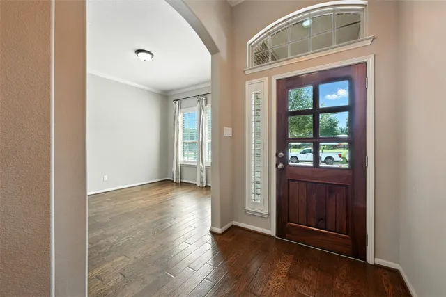 a bedroom with a large bed and a flat tv screen