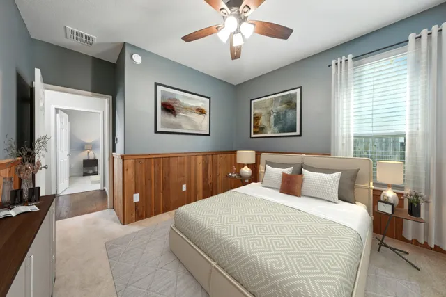 a kitchen with stainless steel appliances granite countertop a sink dishwasher a stove a refrigerator and island with wooden floor